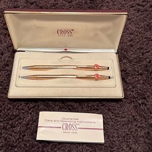 Vintage cross pen and pencil set with the recycler logo in red.  Gold